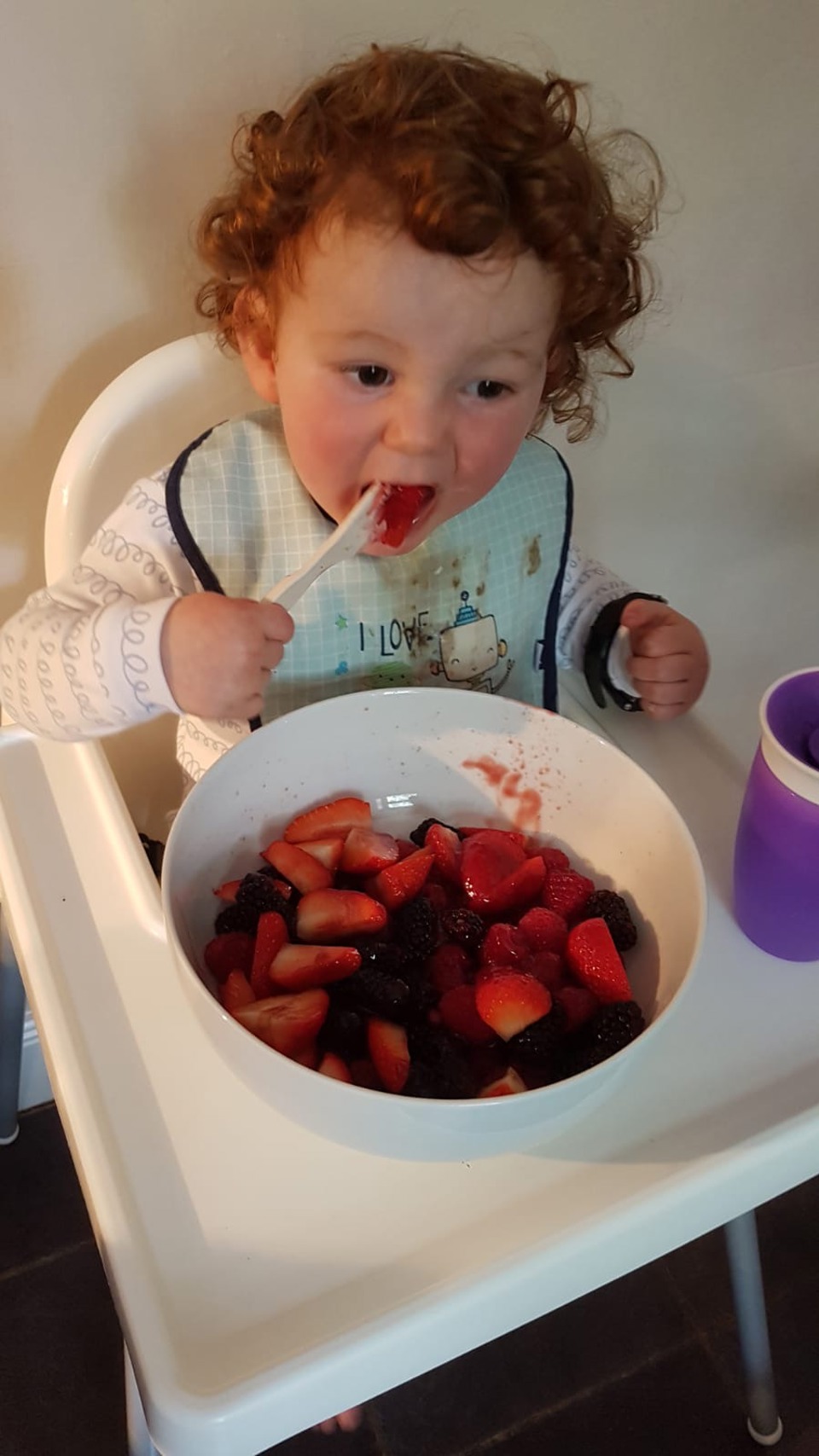 toddler eating fruit