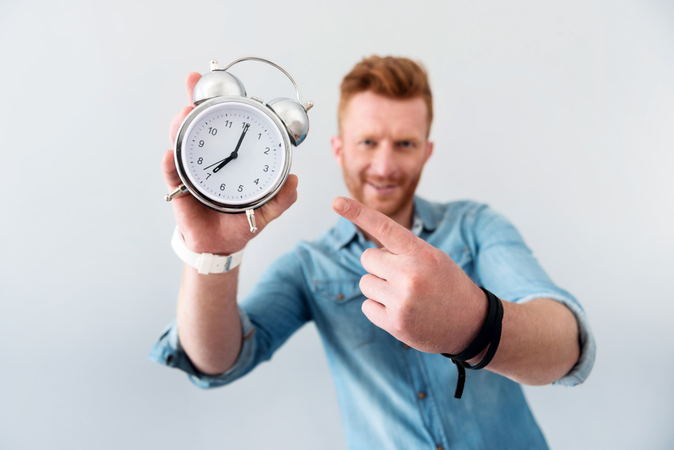 Man showing the time on a clock