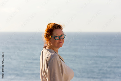 woman smiling infront of sea