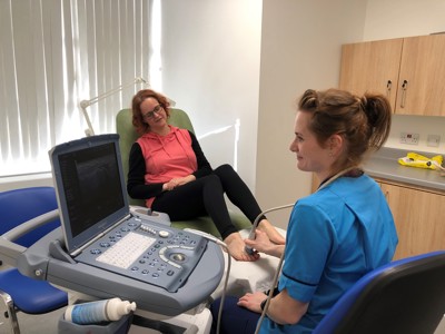 nurse ultra scanning patients foot