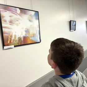 Boy Looks At Photo
