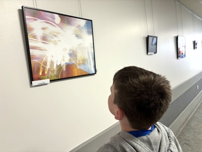 Boy Looks At Photo