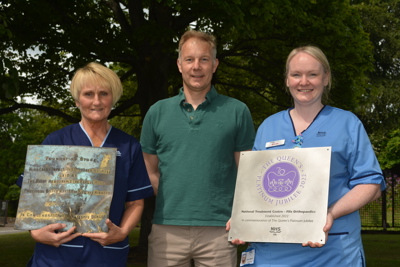 Staff Holding Jubilee Plaques