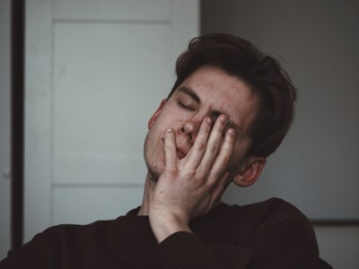 young man with face in hand 