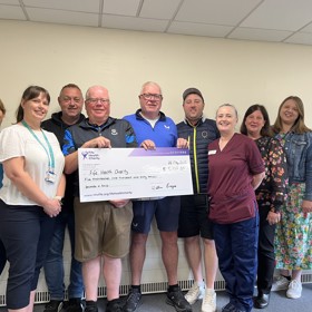 Group shot donating cheque