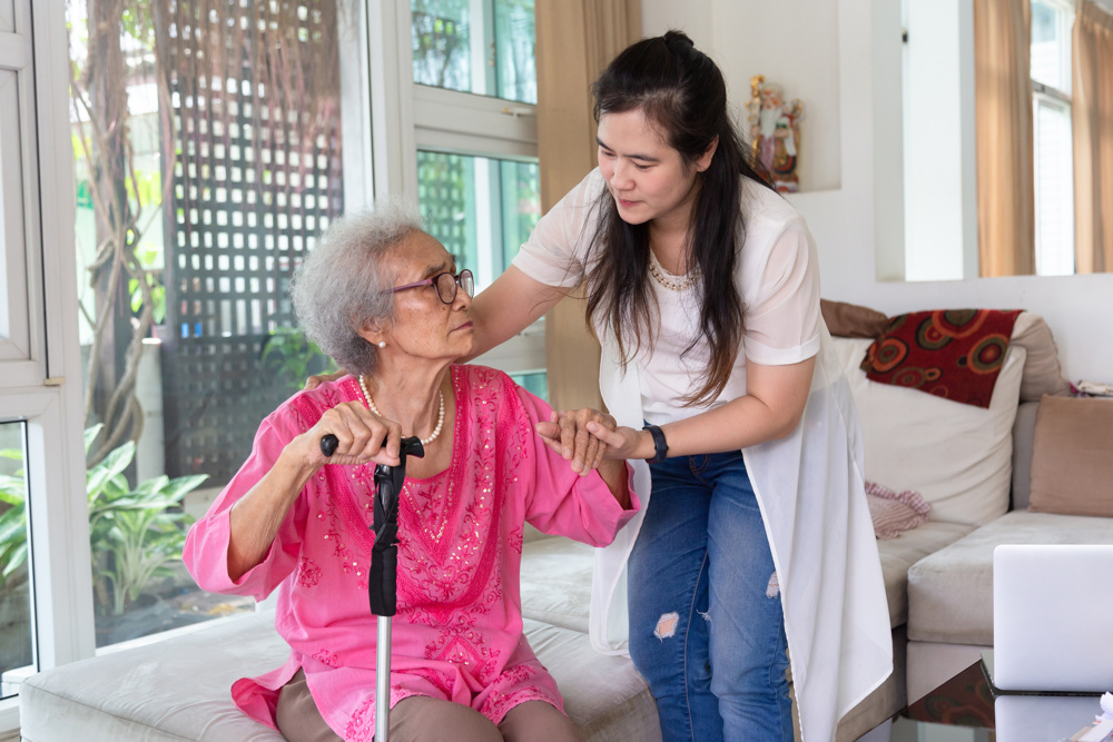 Elderly woman and carer