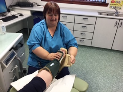 nurse putting brace on patients foot