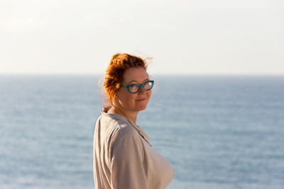 woman smiling with ocean in background