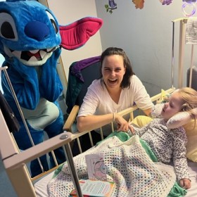 Costumed character with child at bedside