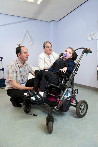 Doctors with young wheelchair user