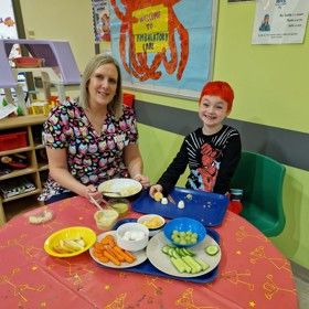 Parent and child with food on table