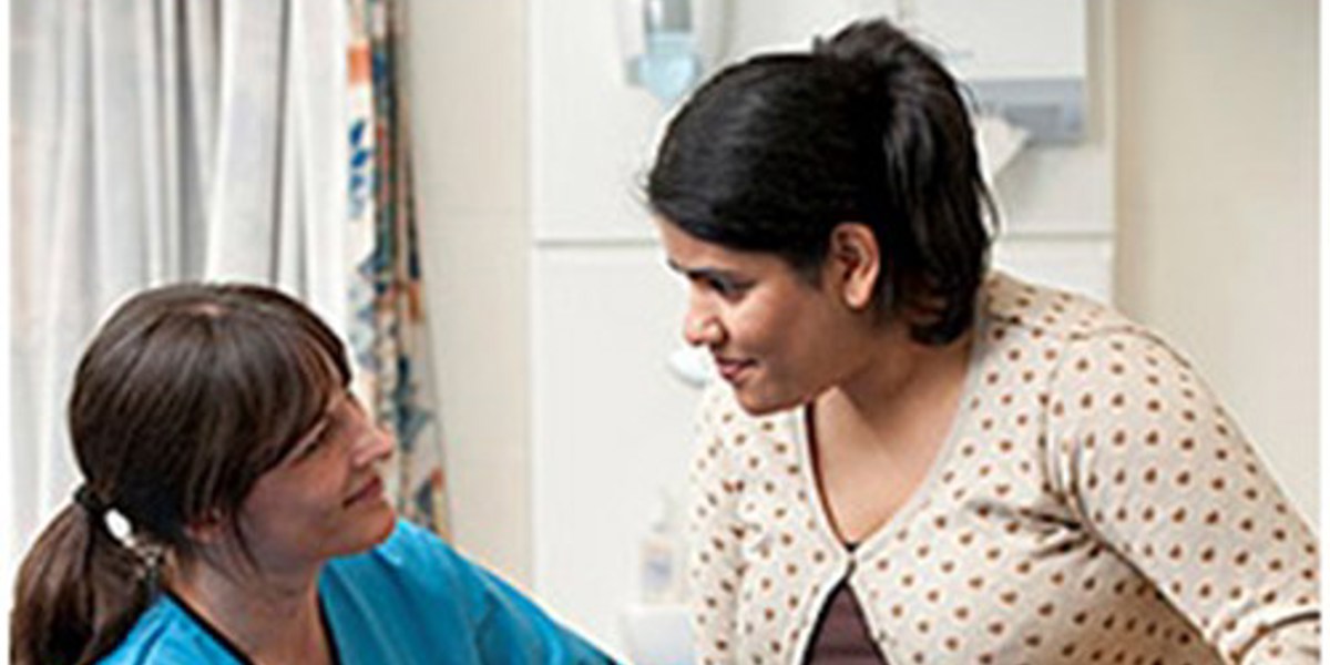 nurse helping patient put on shoe