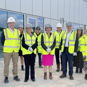 Chief executive and director with group of people wearing Hi vis vests and helmet