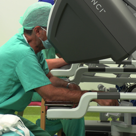 Surgeon operating on machine