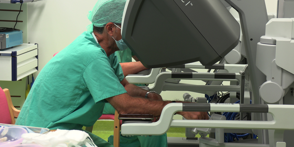Surgeon operating on machine