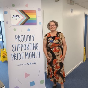 Woman Beside Pride Banner