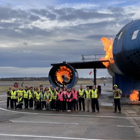 Students outside airplane simulation training