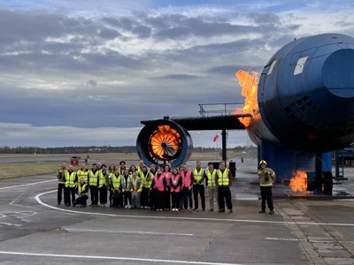 Students outside airplane simulation training