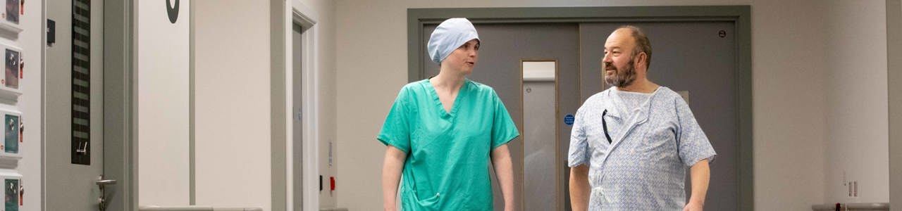 Patient walking to surgery with staff