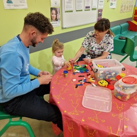 Parents and young child at table