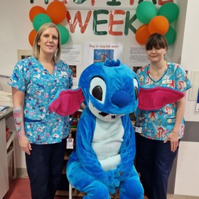 costumed character with two women