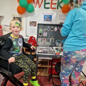 Young boy sitting during Play at hospital week