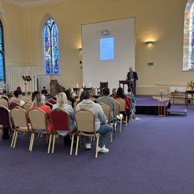 Wide image of the organ donation memorial event from the rear of the church.