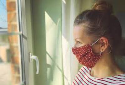 Woman at home with mask on