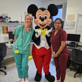 Mickey mouse with staff members