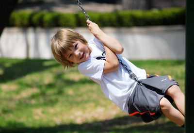 young boy swinging