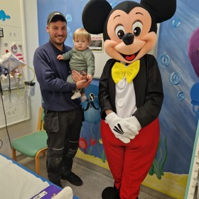 Mickey mouse with young child and parent