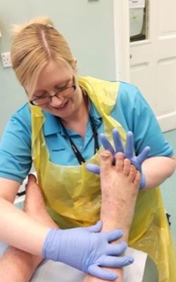 nurse inspecting patients foot