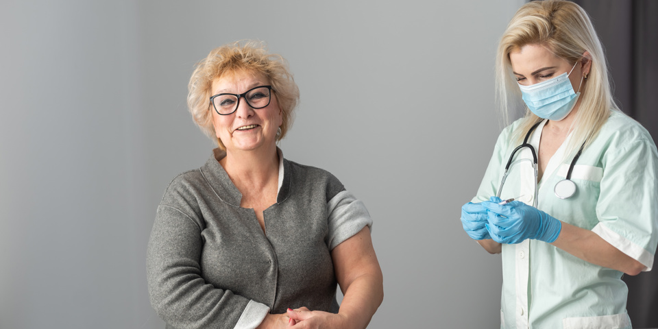 doctor getting jag ready for happy older patient