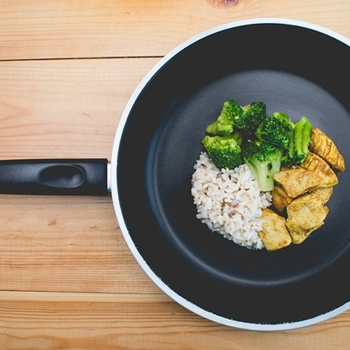 frying pan with rice chicken and broccoli