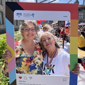 Two women with Pride banner