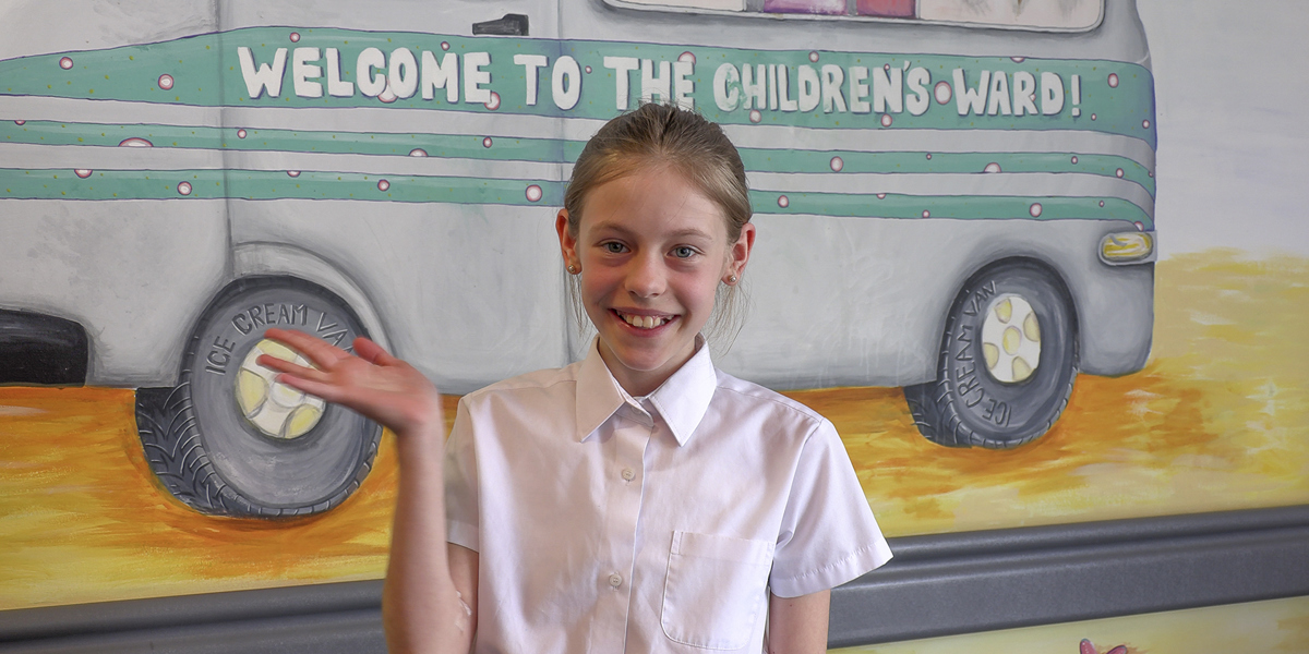 Girl waving in the children's unit