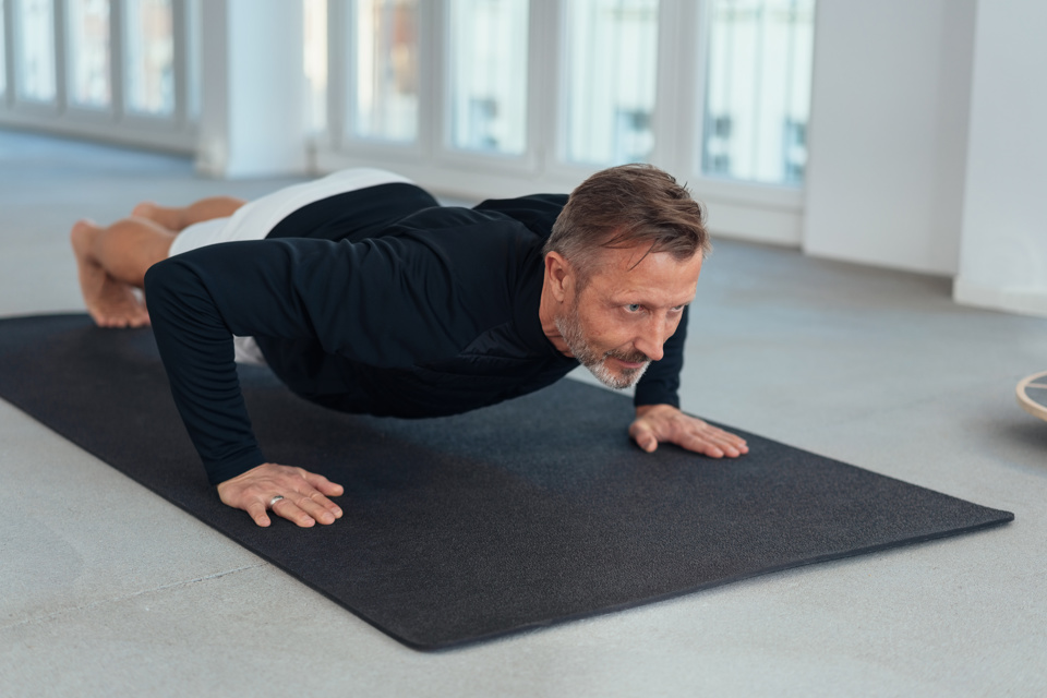 Older Adult Male Doing Exercise At Home