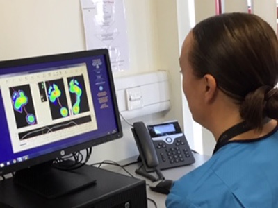 physio looking at patients foot scan