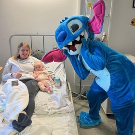 Costumed character with child at bedside