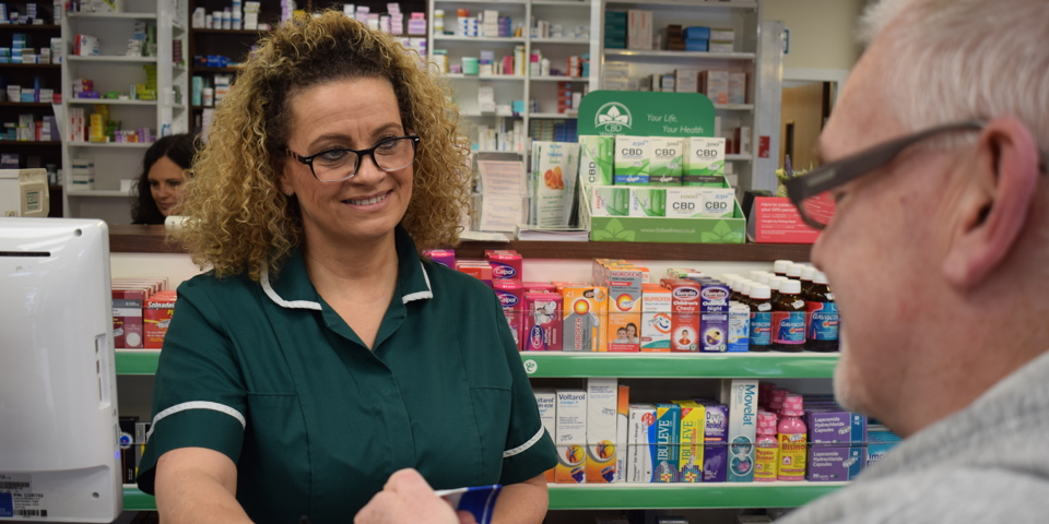 Pharmacy staff serving customer