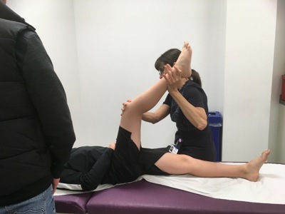 Physio holding patients leg